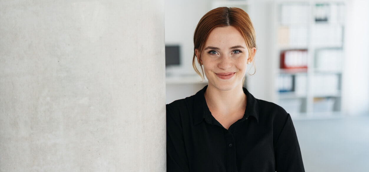 Friendly young businesswoman smiling at camera